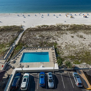 Enjoy a stunning beachfront view from this inviting pool area, perfect for relaxation and sun-soaked days
