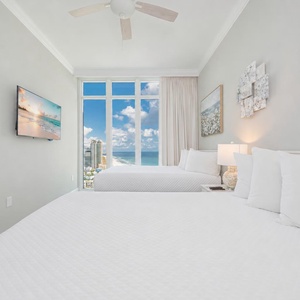 Enjoy a good movie and unwind in this charming queen guest suite with cozy beds and stunning views