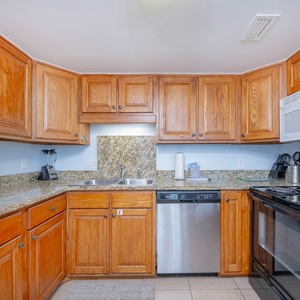 Warm wood cabinets frame your kitchen where you blend fresh coastal flavors and laughter around the breakfast bar