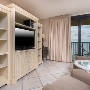 Living area with plush seating and a breathtaking view through sliding glass doors that leads to the beachfront balcony