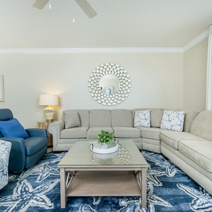 Unwind in the inviting living area, featuring a plush sectional, stylish decor, and a cozy atmosphere for relaxation