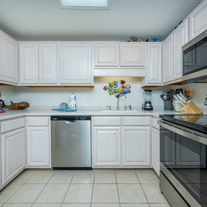 Prepare meals in this inviting kitchen featuring ample counter space and stainless appliances for your culinary adventures