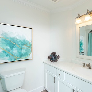 Refresh in the stylish guest bathroom featuring a large mirror, decorative accents, and ample counter space for essentials