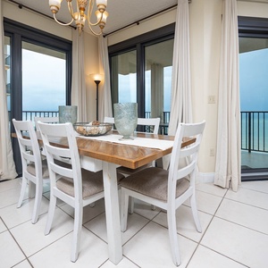 Dine at the rustic table surrounded by beachfront views from the balcony