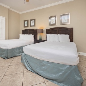 Find comfort in this inviting guest room, featuring two queens and fluffy pillows for a restful atmosphere