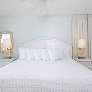 Drift into peaceful sleep in the master suite, with gentle coastal light filtering through airy curtains