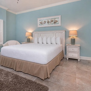 Drift into serenity on the king bed in the guest suite, illuminated by soft light that enhances the coastal vibe