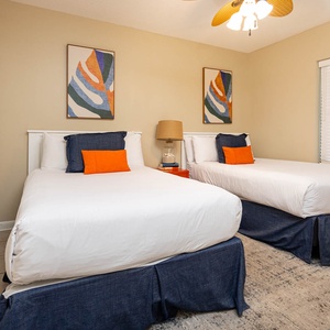Relax in this cheerful guest bedroom featuring two twin beds, colorful accents, and a cozy atmosphere for restful nights
