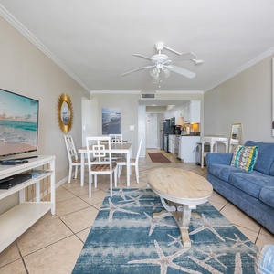 Blue couch embraces you in the living room where you unwind watching your favorite show on TV