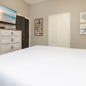 Unwind in this guest bedroom featuring a queen bed, tasteful decor, and a TV for your entertainment