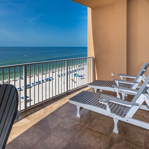Relax on the balcony loungers while enjoying stunning views of the beach and tranquil waters