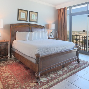 Retreat to the king master suite with cozy bedding and drift off to the sound of the waves from the balcony