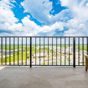 Stunning views from the private balcony overlooking lush greenery and vibrant city life