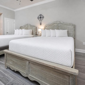 Relax on one of the cozy queen beds in this guest suite and enjoy a restful retreat