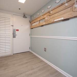 Step into a welcoming entryway featuring stylish hooks for your belongings and a light, airy color palette