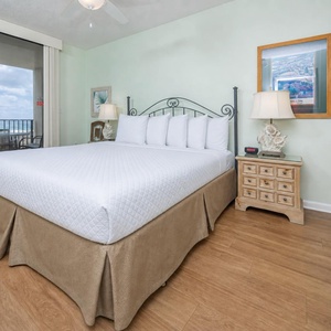 Retreat to the king master suite with cozy bedding and drift off to the sound of the waves from the balcony