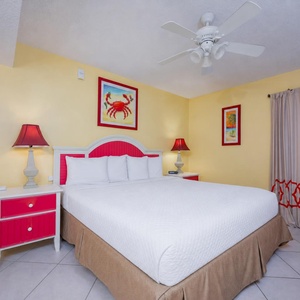 Drift into relaxation on the plush king bed, surrounded by cheerful decor that invites beachside dreams