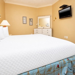 Relax on the cozy king bed in this guest suite and enjoy a movie after a beach day