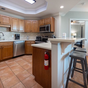 Prepare meals in this kitchen with elegant cabinetry, stainless appliances, and spacious countertops