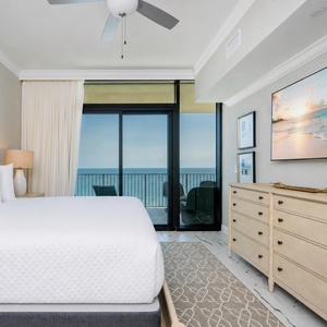 Unwind in the master suite with a cozy king bed, stylish decor, and beachfront balcony access