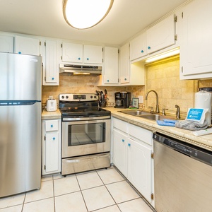 Craft delicious meals together in this inviting kitchen, featuring stainless appliances and charming coastal accents