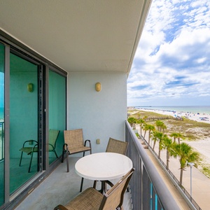 Gaze at the expansive shoreline and vibrant beachside scene from your comfortable west corner balcony