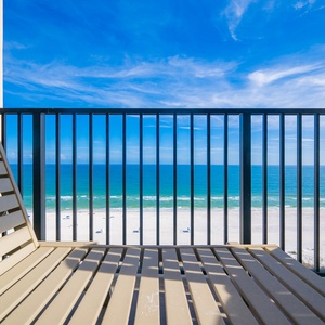 Your view of the glistening coast beneath soft, wispy clouds overhead