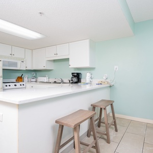 Prepare meals in the kitchen featuring a spacious countertop, large and small appliances, perfect for culinary adventures