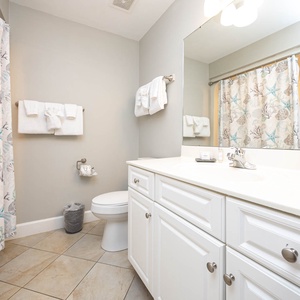 Enjoy a relaxing shower after a day of adventure in this guest bath with stylish accents and fluffy towels