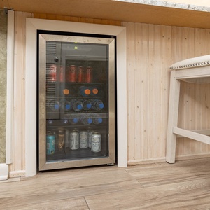 Enjoy refreshing beverages from the sleek mini-fridge, conveniently located near the stylish bar seating