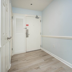 Step into this welcoming entryway featuring light blue walls, stylish trim, and easy access to your vacation retreat