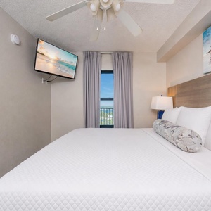 Fluffy pillows invite you to relax in the king suite for a calm movie night after a fun day at the beach