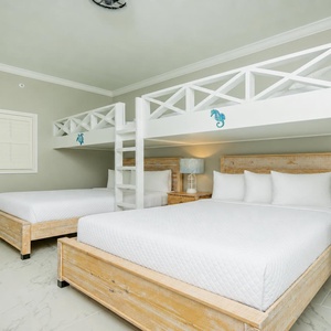 Cheerful guest bedroom featuring a two queen beds and charming twin loft bunk beds, perfect for family fun
