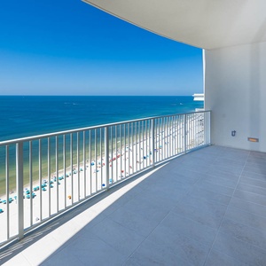 Breathe in the fresh air while enjoying expansive views from the spacious balcony overlooking the beach and water