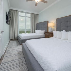 Imagine waking to coastal views in this queen guest suite, sinking into pillowy bedding, then turning on a movie