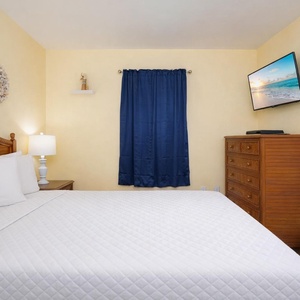 Sink into softness on the plush bedding, surrounded by charming coastal decor in your welcoming bedroom