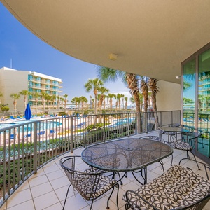 Breathe in the fresh air from the balcony while enjoying glimpses of the inviting pool and lush palm trees