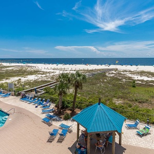 Refreshing pool area with lounge chairs and easy access to the beach, perfect for relaxation and fun