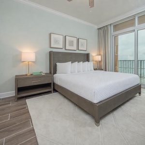 Retreat to the king master suite with cozy bedding and drift off to the sound of the waves from the balcony