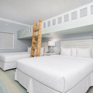 Unwind in this charming bunk room featuring two queens below and a ladder to a cozy lofted area with two twin beds