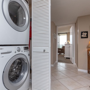 Bright and inviting laundry area featuring modern LG appliances, with a cozy living space visible in the background