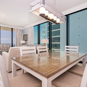 Elegant dining table surrounded by stylish decor and stunning beach views