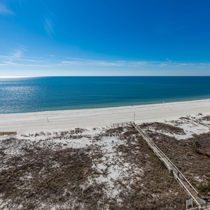 Gaze at the tranquil waters and soft shoreline, perfect for leisurely strolls and sun-soaked relaxation