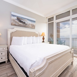 Retreat to the king master suite with cozy bedding and drift off to the sound of the waves from the balcony