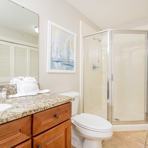 Additional bath featuring a walk-in shower, elegant granite countertop, laundry area with washer/dryer, and plush towels