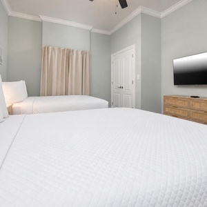 Curl up in a queen bed and surround yourself with fluffy pillows in this guest suite and drift off into a peaceful slumber