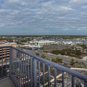 Balcony view from the master with a serene landscape, nearby marina, and charming coastal homes in the distance