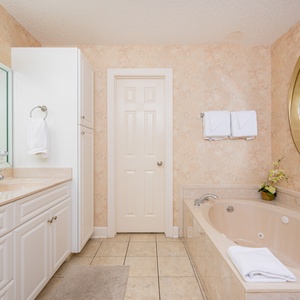 Refresh in the master bath after a day at the beach with a soothing jetted tub and relaxing walk-in shower