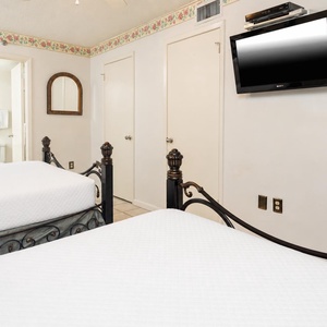 Relax in this inviting guest room with two queen beds, decorative accents, and a flat-screen TV
