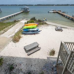 This view showcases colorful kayaks on the sandy beach, perfect for a fun-filled day by the lagoon